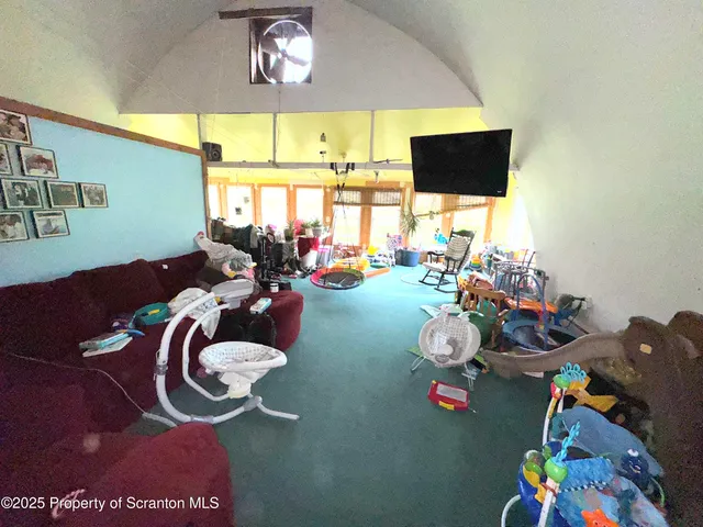 a living room with furniture and a floor to ceiling window
