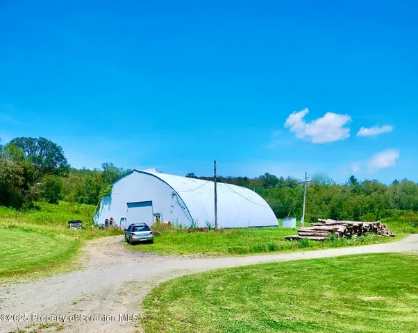 a view of a house with backyard and a garden
