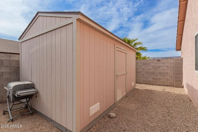 a backyard of a house with table and chairs