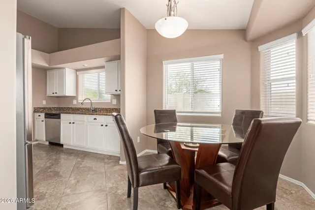 a view of a dining room with furniture and windows