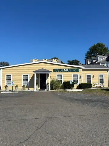 a front view of a house with a road