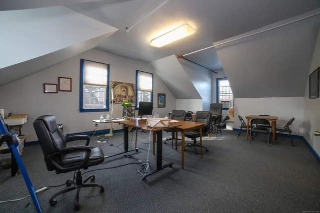 a view of a livingroom with furniture and a window