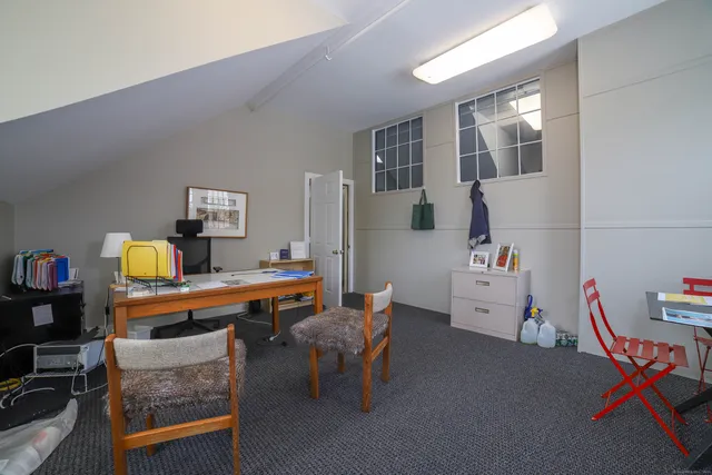 a room with furniture a rug toys and a window