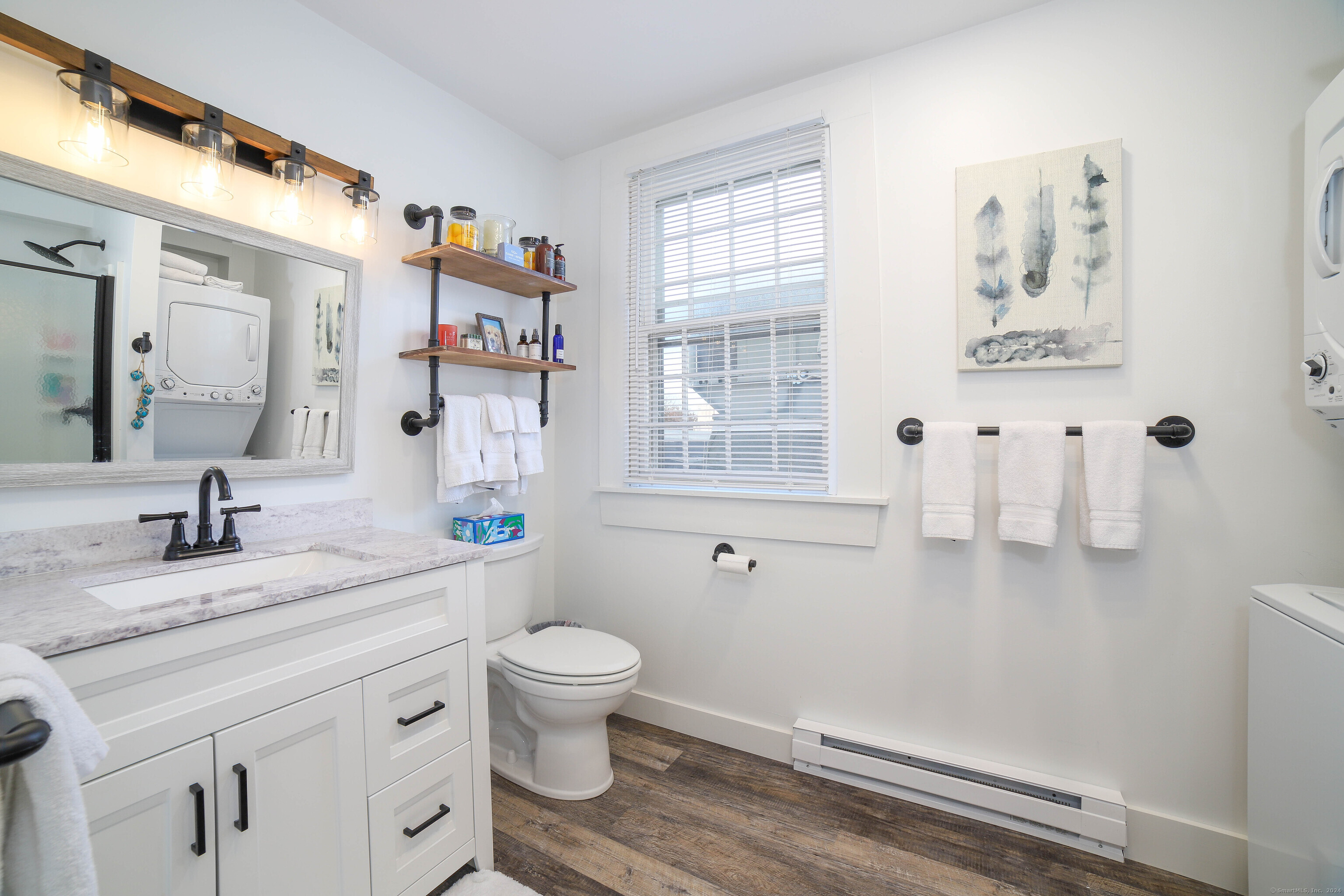 125 Main Street Old Saybrook, CT 06475 - Photo 20 of 30 a bathroom with a granite countertop sink mirror vanity and toilet