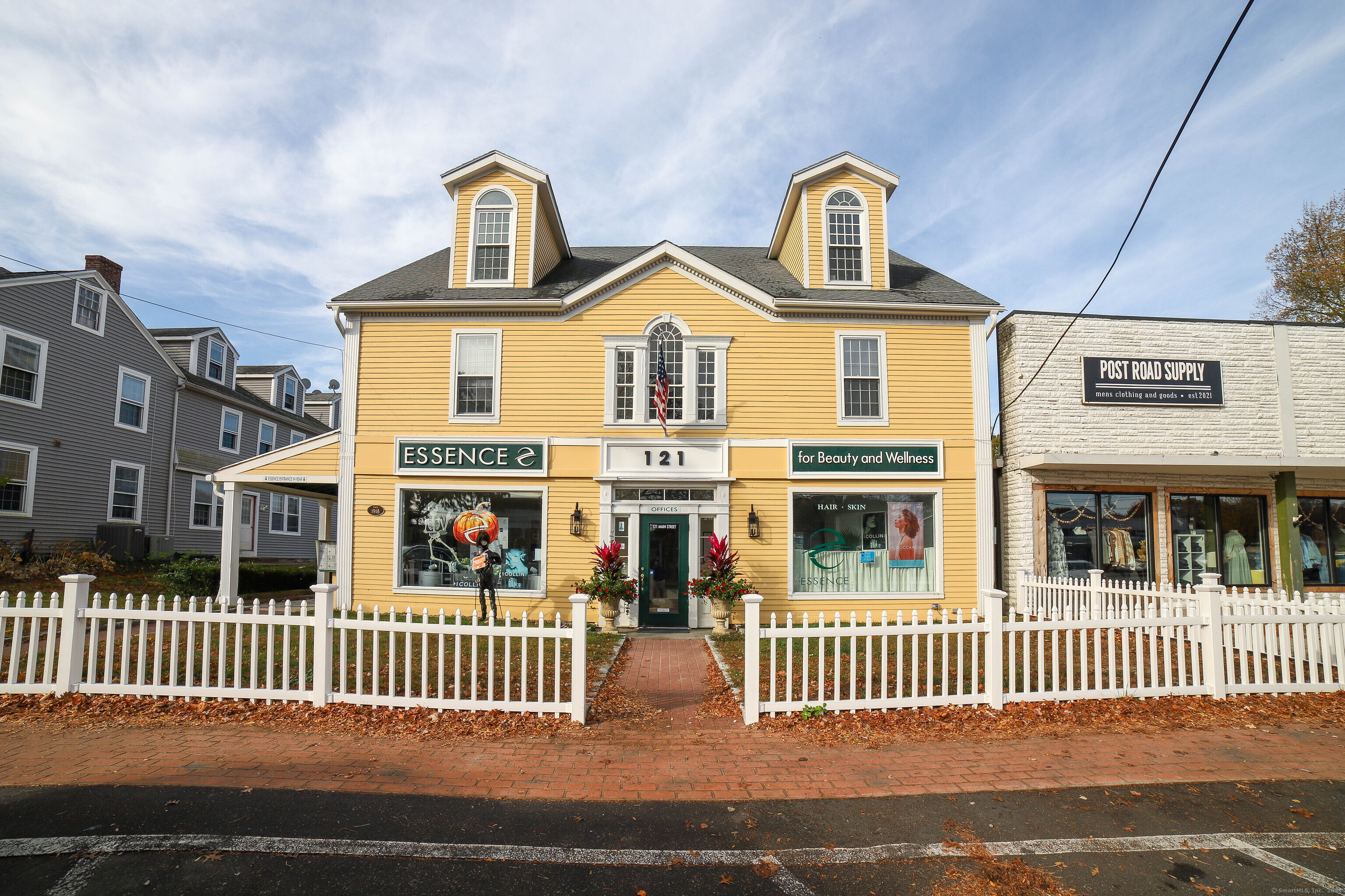 125 Main Street Old Saybrook, CT 06475 - Photo 9 of 30 a front view of a residential apartment building with a bench