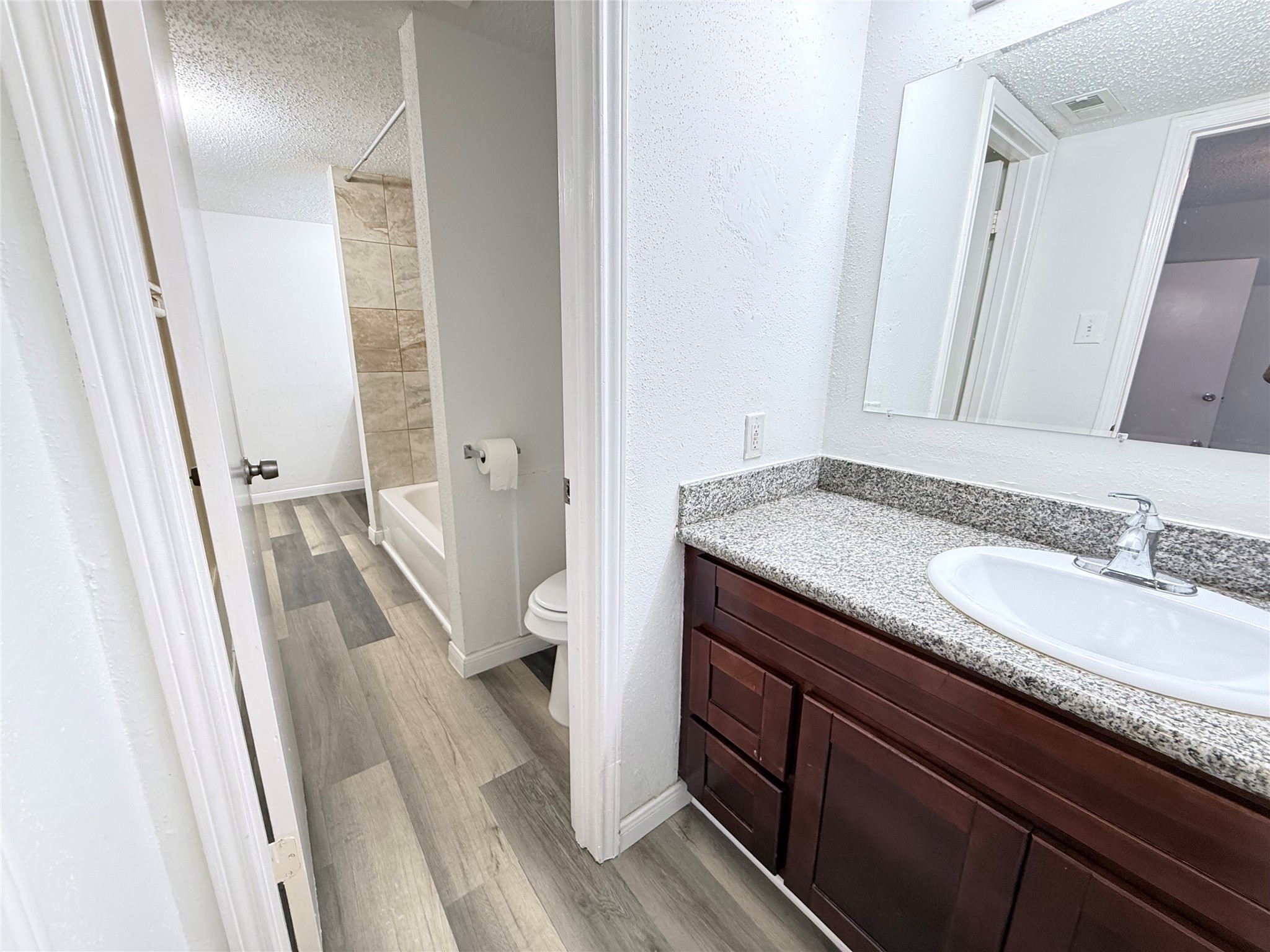 7789 Cook Road Houston, TX 77072 - Photo 18 of 18 a bathroom with a granite countertop sink and a mirror