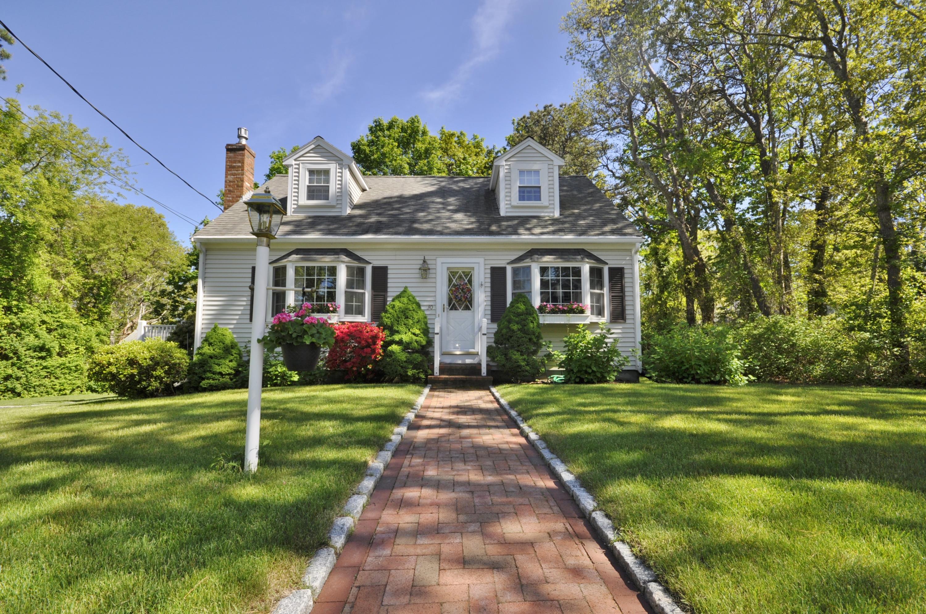 30 Longfellow Road Sagamore Beach, MA 02562 - Photo 1 of 21 a front view of a house with a yard