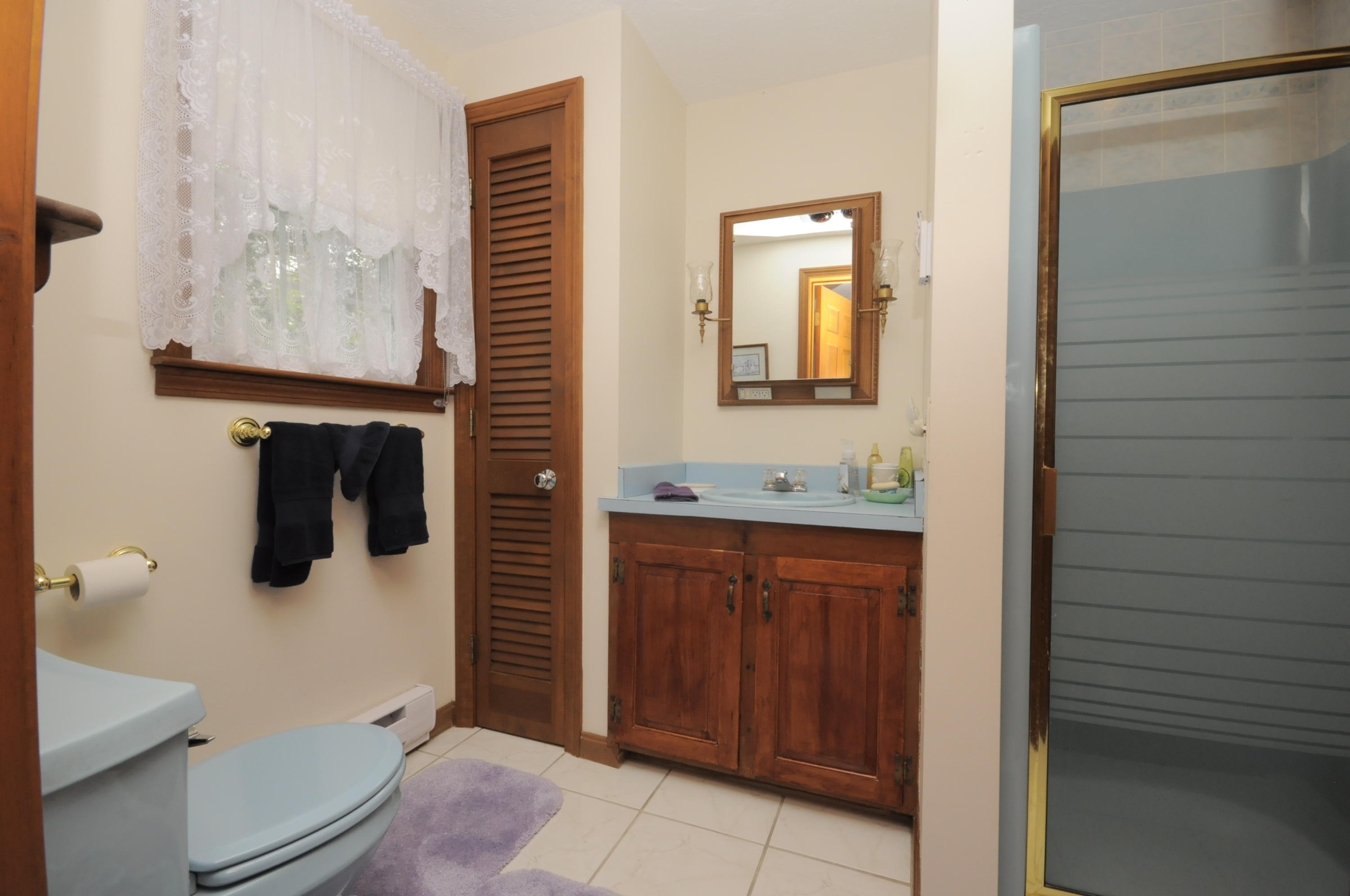 30 Longfellow Road Sagamore Beach, MA 02562 - Photo 14 of 21 a bathroom with a sink a mirror and shower
