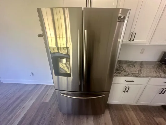 a view of washer and dryer with wooden floor