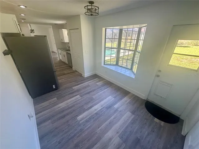 a view of empty room with wooden floor and fireplace