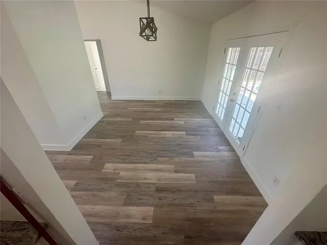wooden floor in an empty room with a fireplace