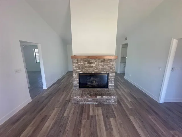 a bathroom with a granite countertop sink toilet mirror and shower