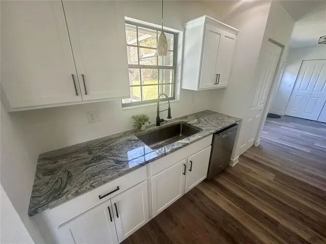 a bathroom with a sink and a window