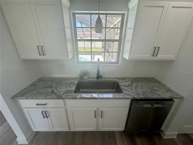 a view of a refrigerator in kitchen and wooden floor
