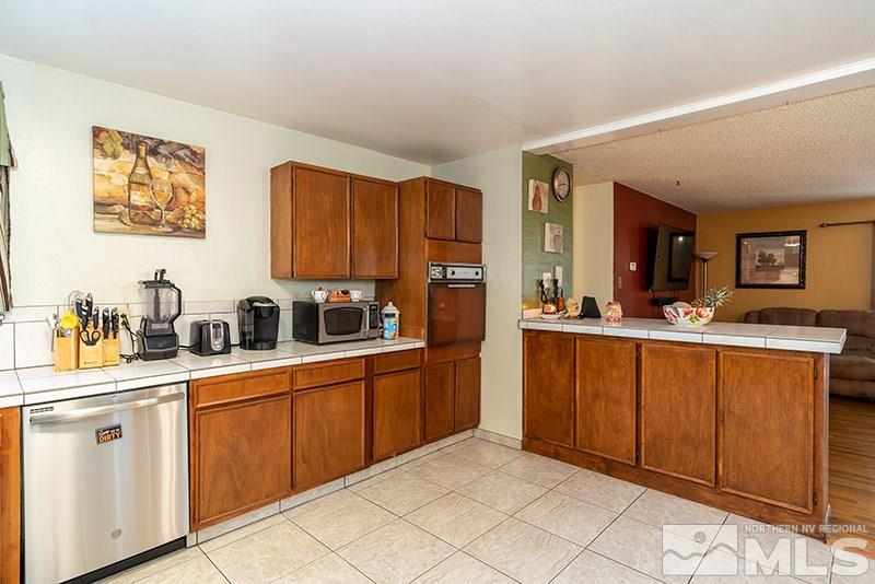 3450 Bryan Street Reno, NV 89503 - Photo 11 of 18 a kitchen with stainless steel appliances a sink stove and cabinets