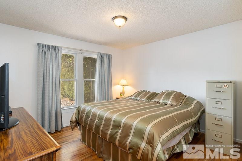 3450 Bryan Street Reno, NV 89503 - Photo 15 of 18 a bedroom with a bed and a flat tv screen on a dresser