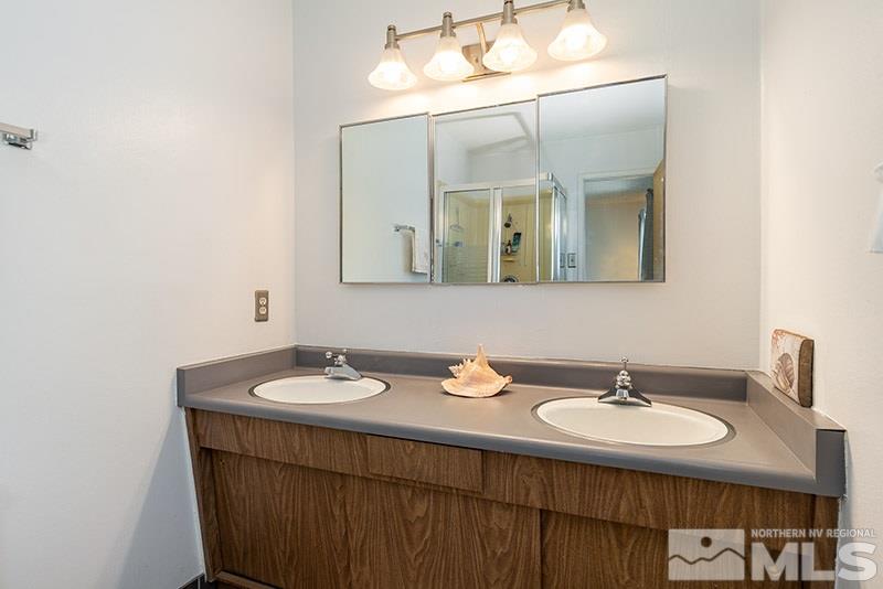3450 Bryan Street Reno, NV 89503 - Photo 16 of 18 a bathroom with a sink and a mirror