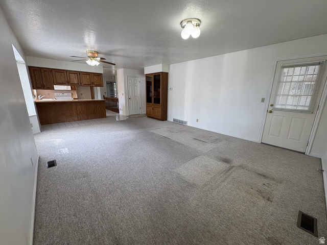 486 West 120 North Orem, UT 84057 - Photo 8 of 30 Open-concept room featuring light-colored carpeting and white wall finishes