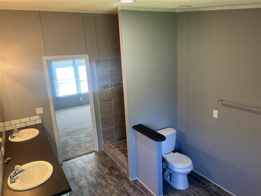 368 Fox Creek Haughton, LA 71037 - Photo 10 of 24 a white toilet sitting next to a bathroom sink and a mirror