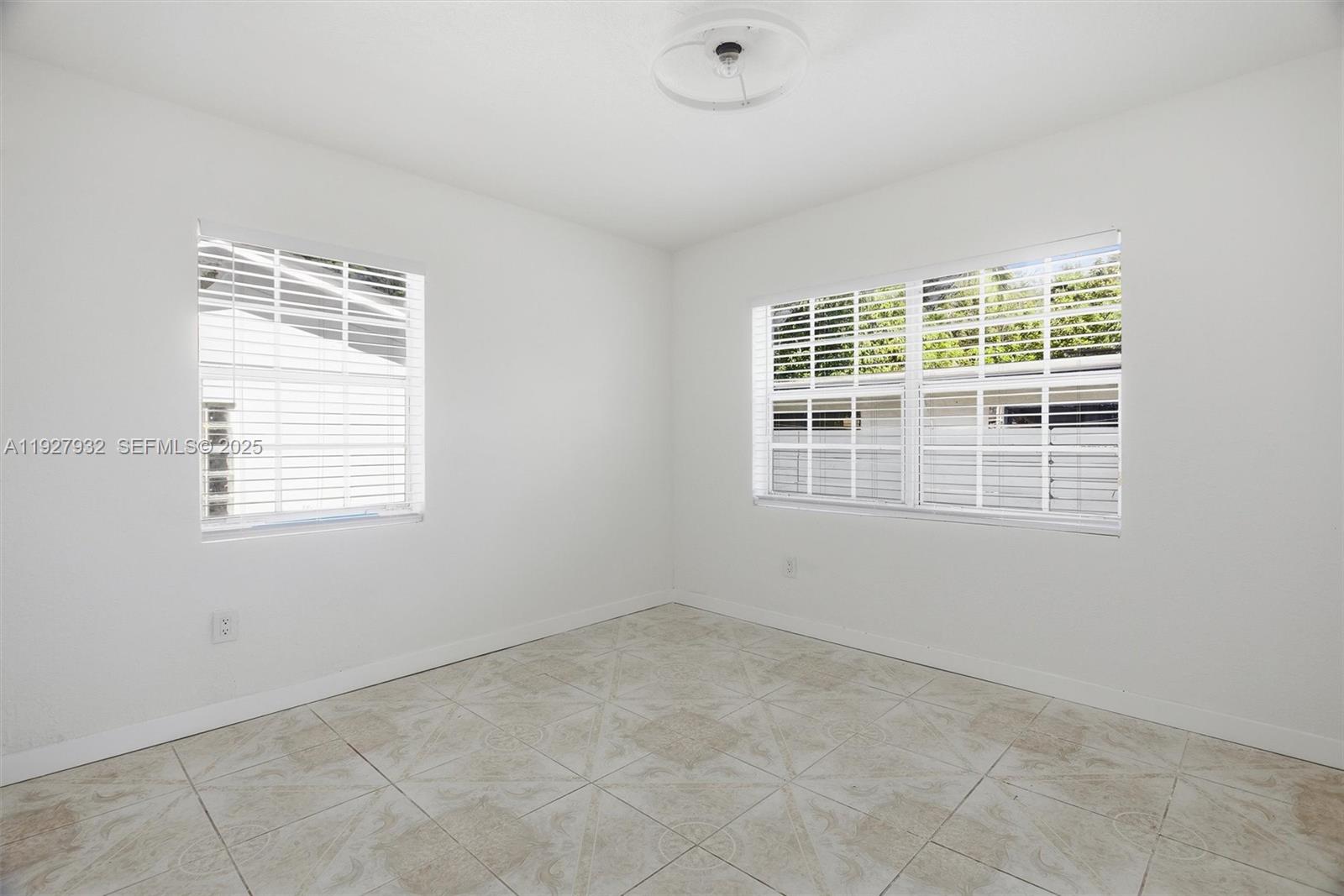 465 Northeast 165th Street, Unit 1 Miami, FL 33162 - Photo 3 of 6 an empty room with a window