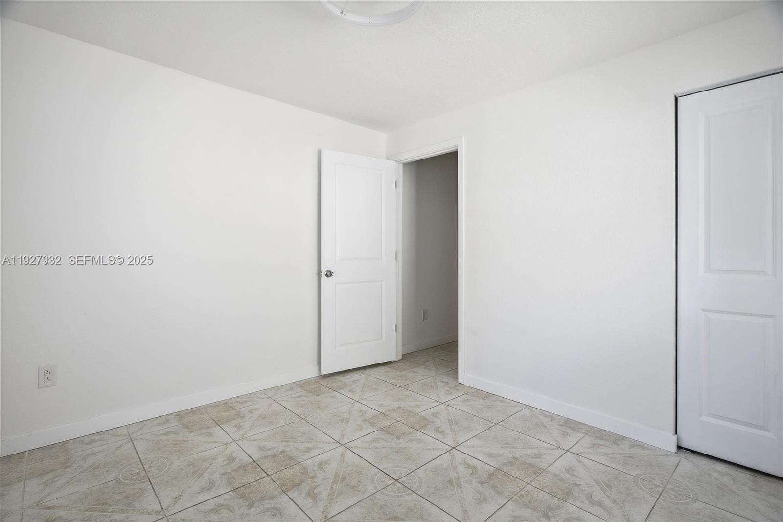 465 Northeast 165th Street, Unit 1 Miami, FL 33162 - Photo 4 of 6 a view of an empty room