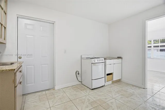 a utility room with cabinets washer and dryer