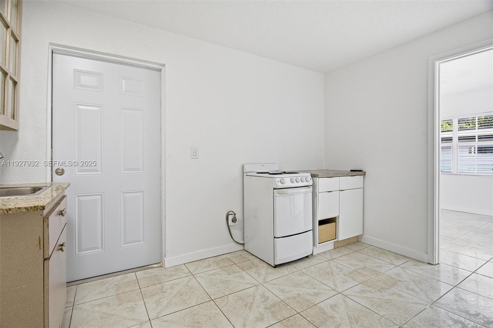 465 Northeast 165th Street, Unit 1 Miami, FL 33162 - Photo 6 of 6 a utility room with cabinets washer and dryer