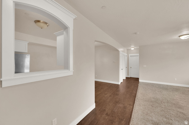 1823 North Crest Road Saratoga Springs, UT 84045 - Photo 4 of 18 Unfurnished room with arched walkways and dark wood-type flooring