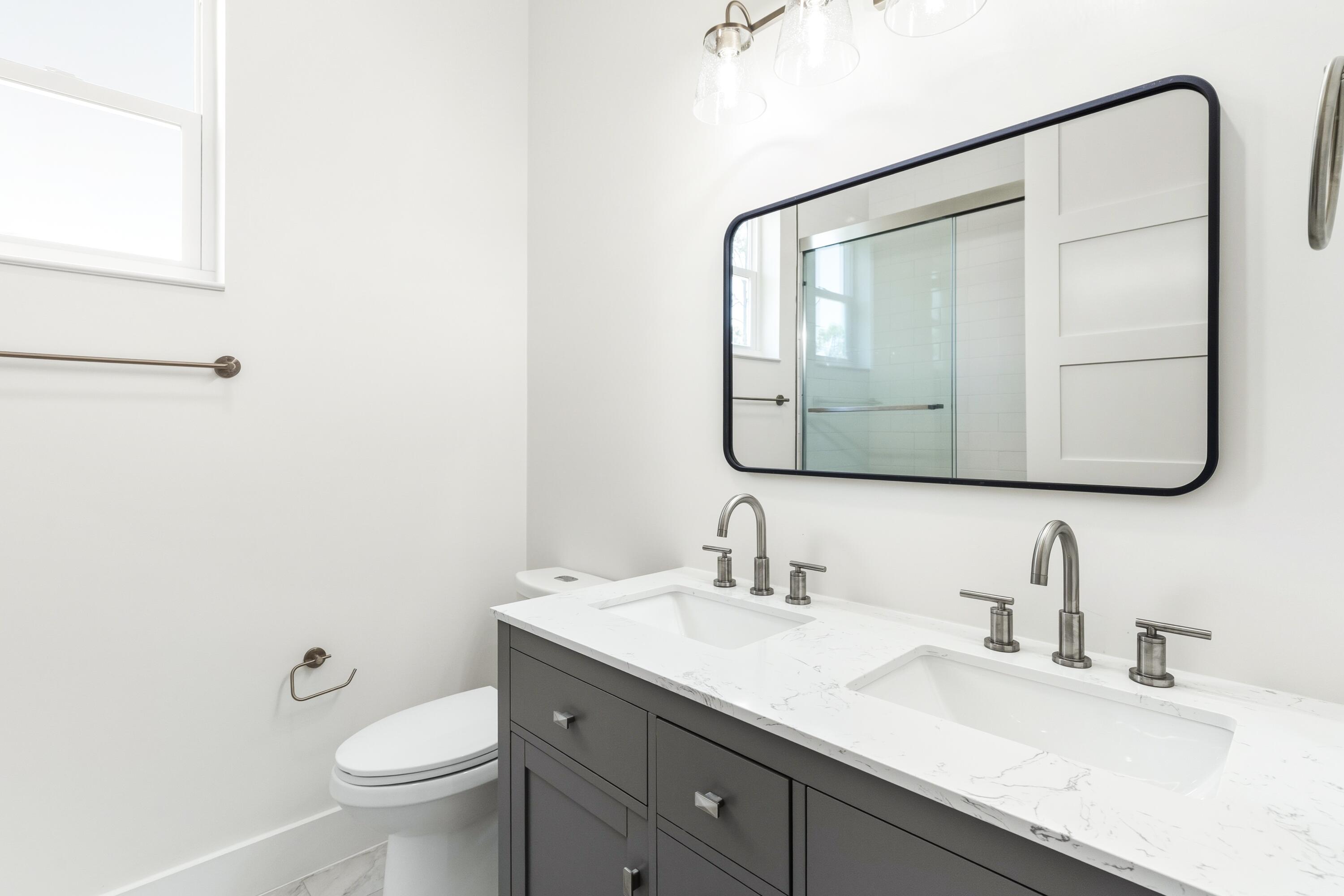 219 Loral Road Santa Rosa Beach, FL 32459 - Photo 20 of 26 a bathroom with a granite countertop sink toilet and mirror