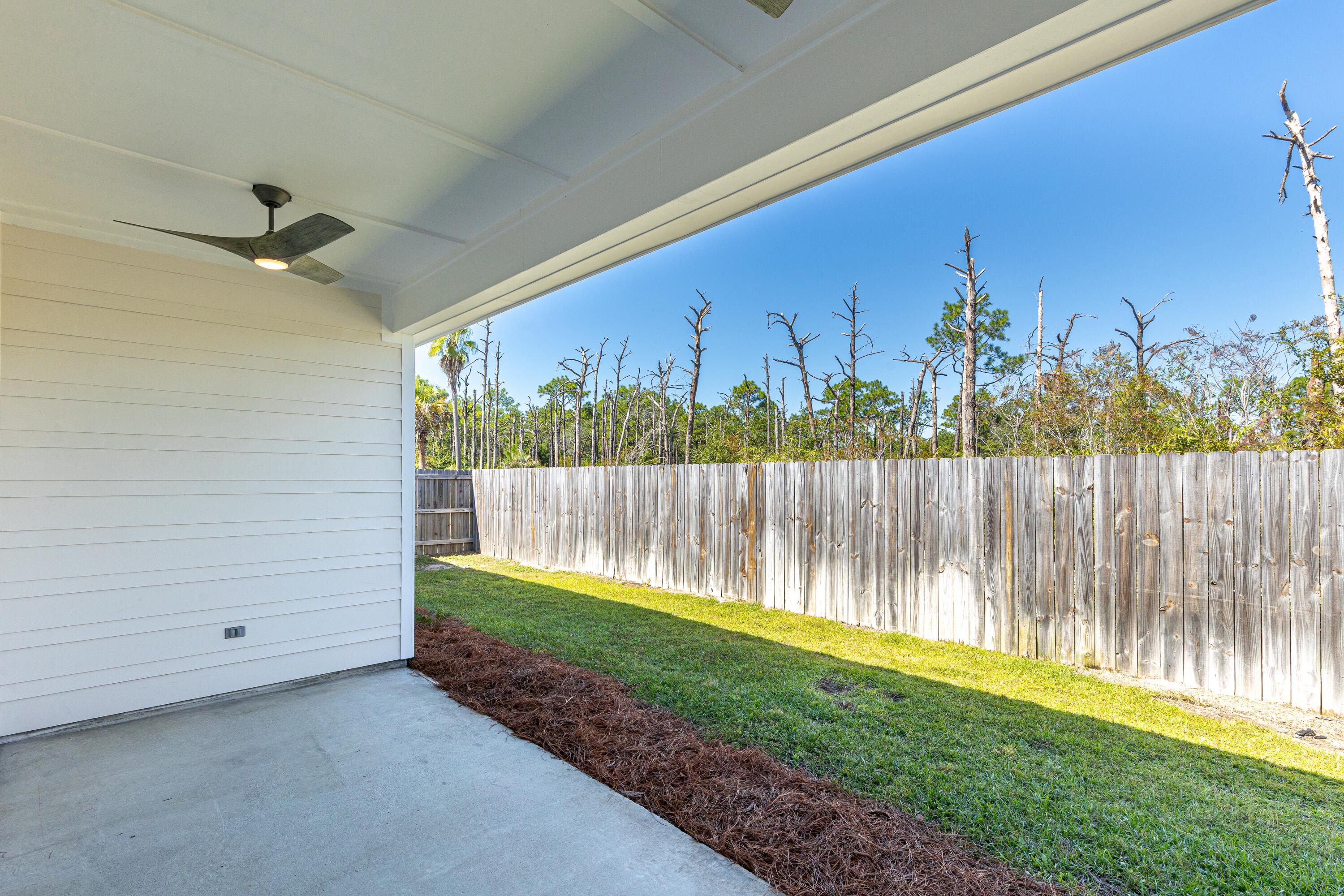 219 Loral Road Santa Rosa Beach, FL 32459 - Photo 23 of 26 a backyard of a house with a lake view