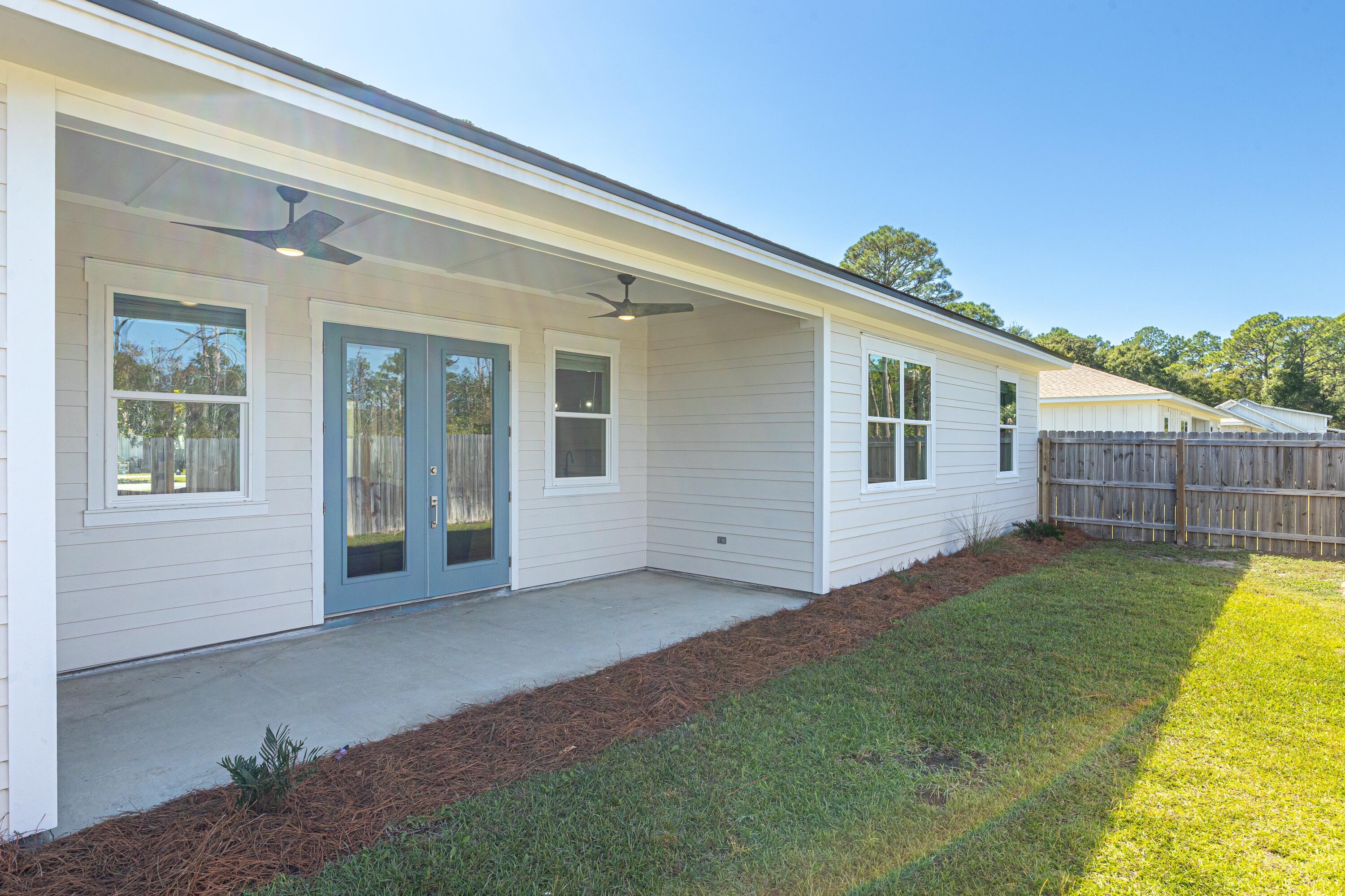 219 Loral Road Santa Rosa Beach, FL 32459 - Photo 24 of 26 a view of a house with a backyard and a patio