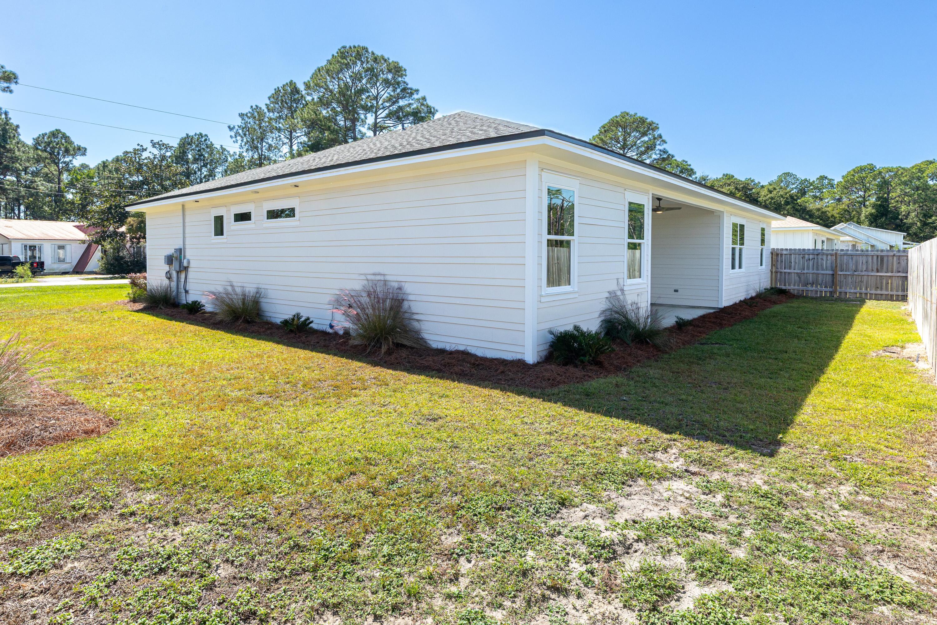 219 Loral Road Santa Rosa Beach, FL 32459 - Photo 26 of 26 a view of a backyard with plants and a patio