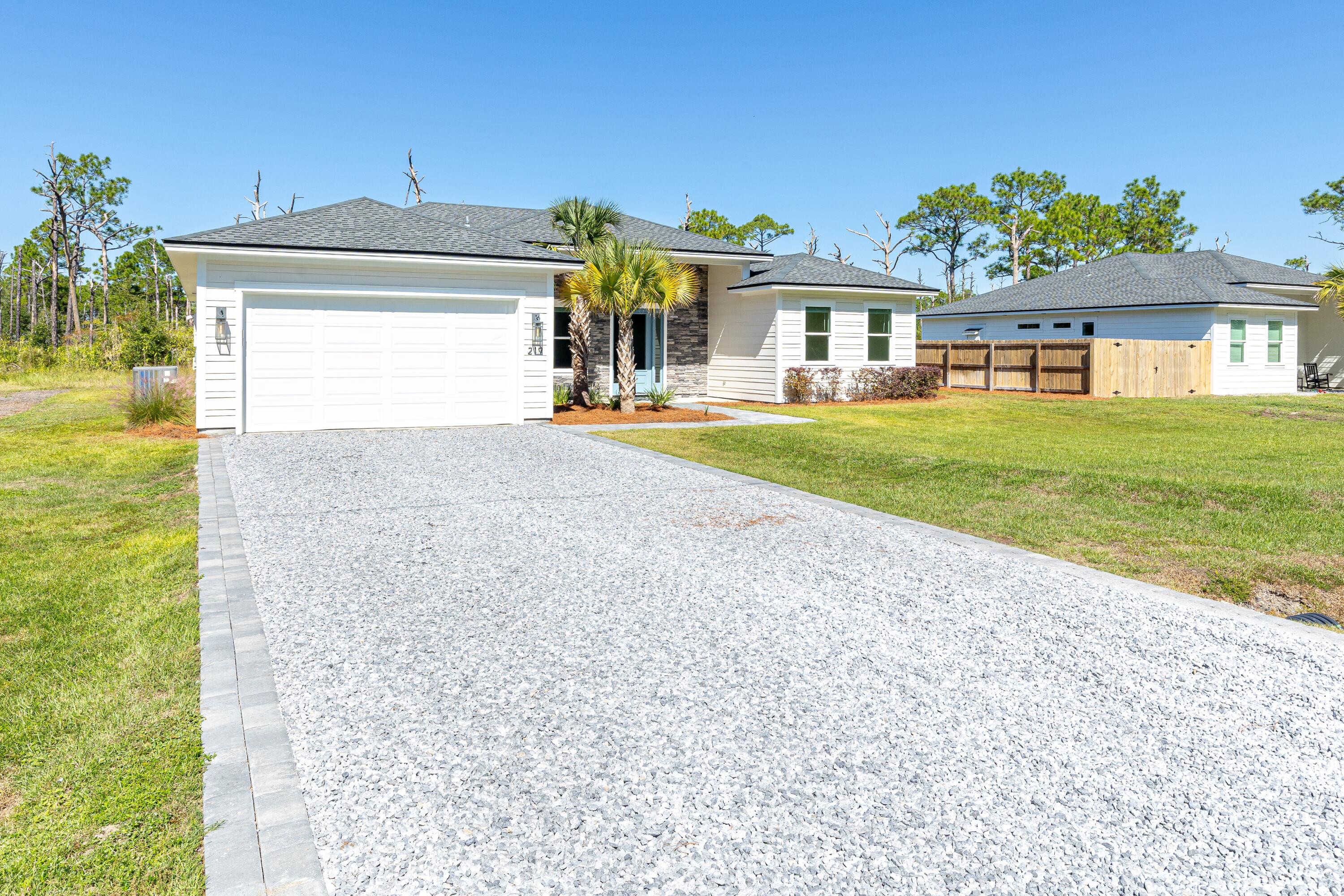 219 Loral Road Santa Rosa Beach, FL 32459 - Photo 3 of 26 a front view of a house with garden