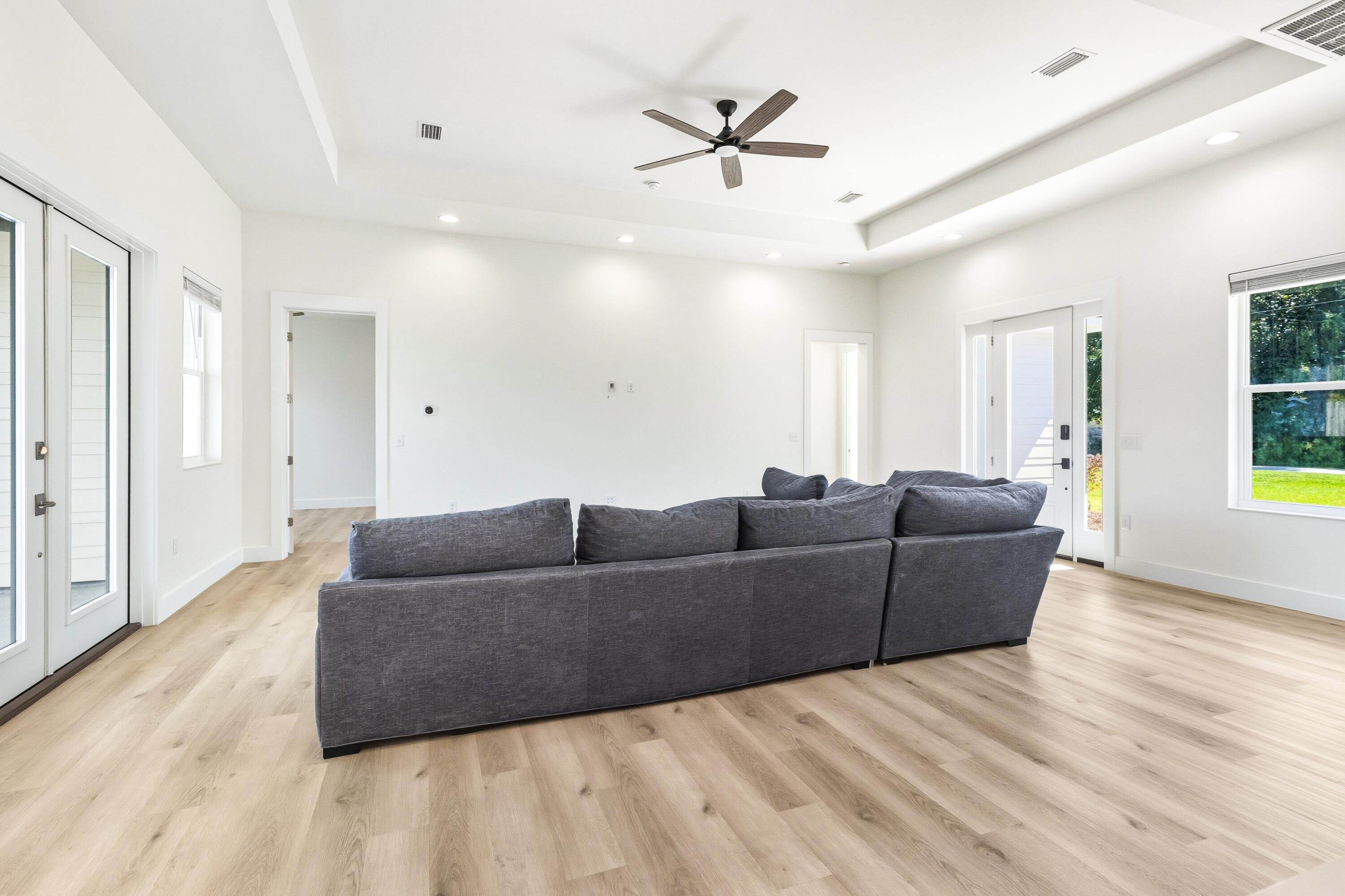 219 Loral Road Santa Rosa Beach, FL 32459 - Photo 7 of 26 a living room with couches and a ceiling fan