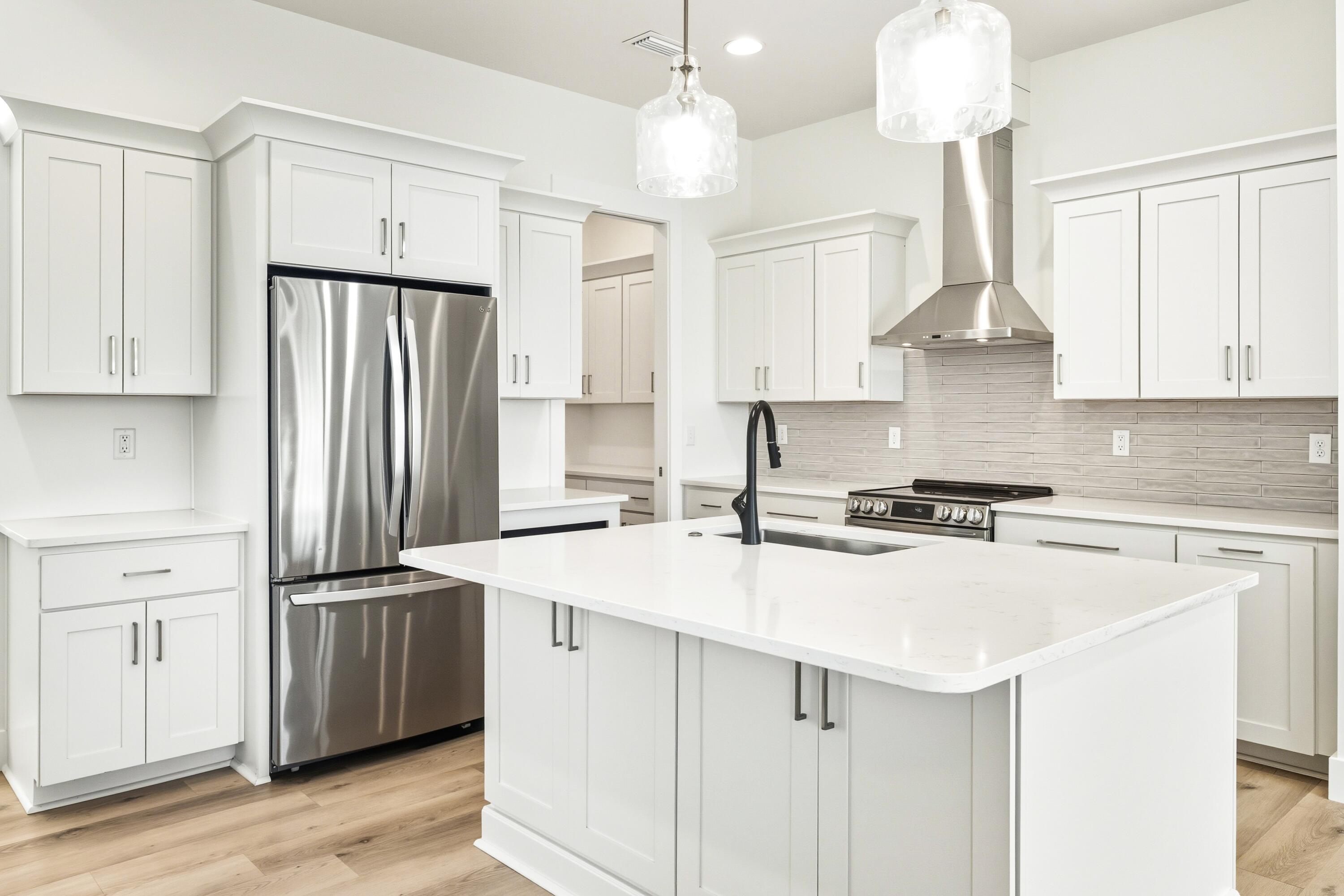 219 Loral Road Santa Rosa Beach, FL 32459 - Photo 8 of 26 a kitchen with stainless steel appliances a sink stove and refrigerator