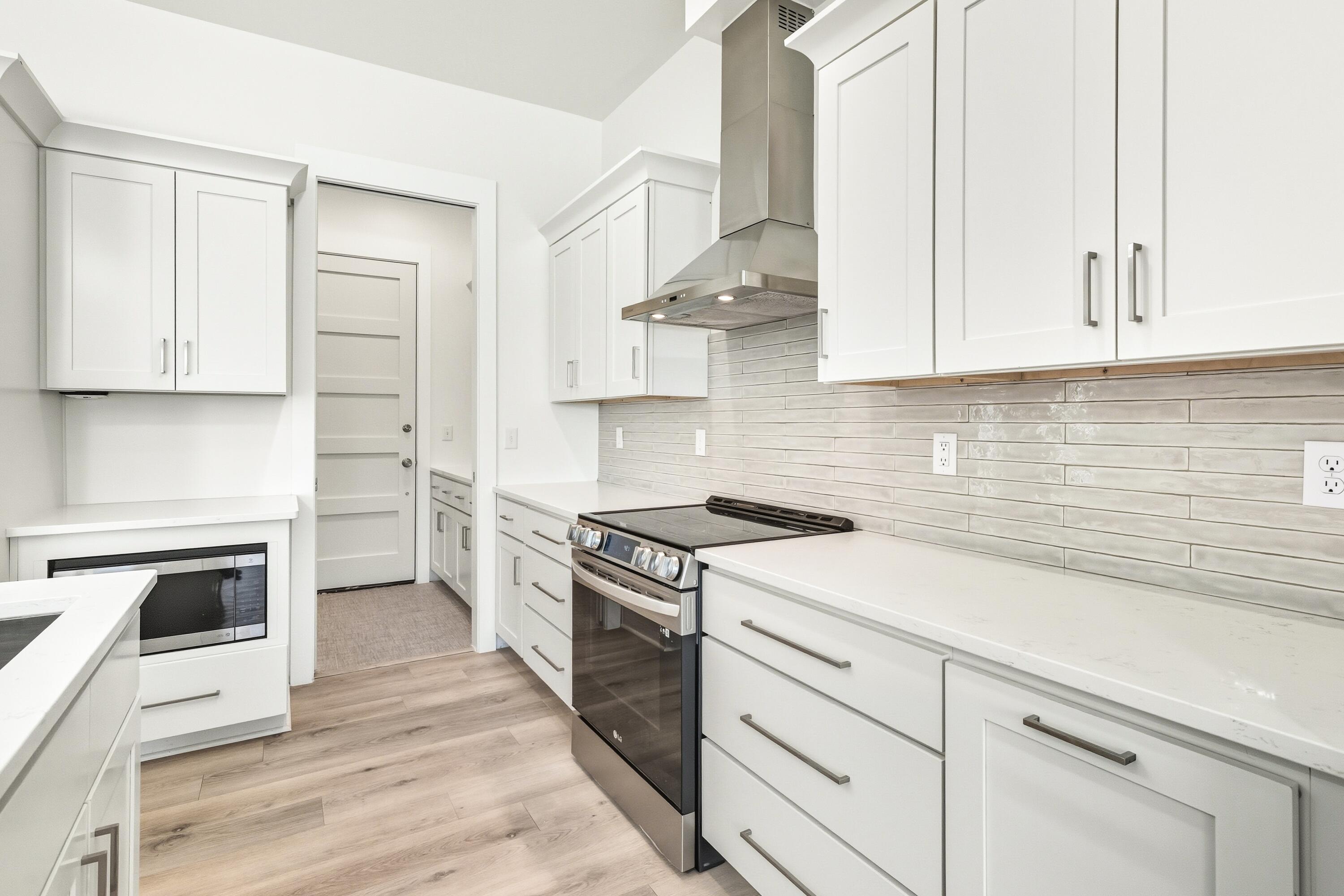 219 Loral Road Santa Rosa Beach, FL 32459 - Photo 9 of 26 a kitchen with cabinets appliances and a wooden floor