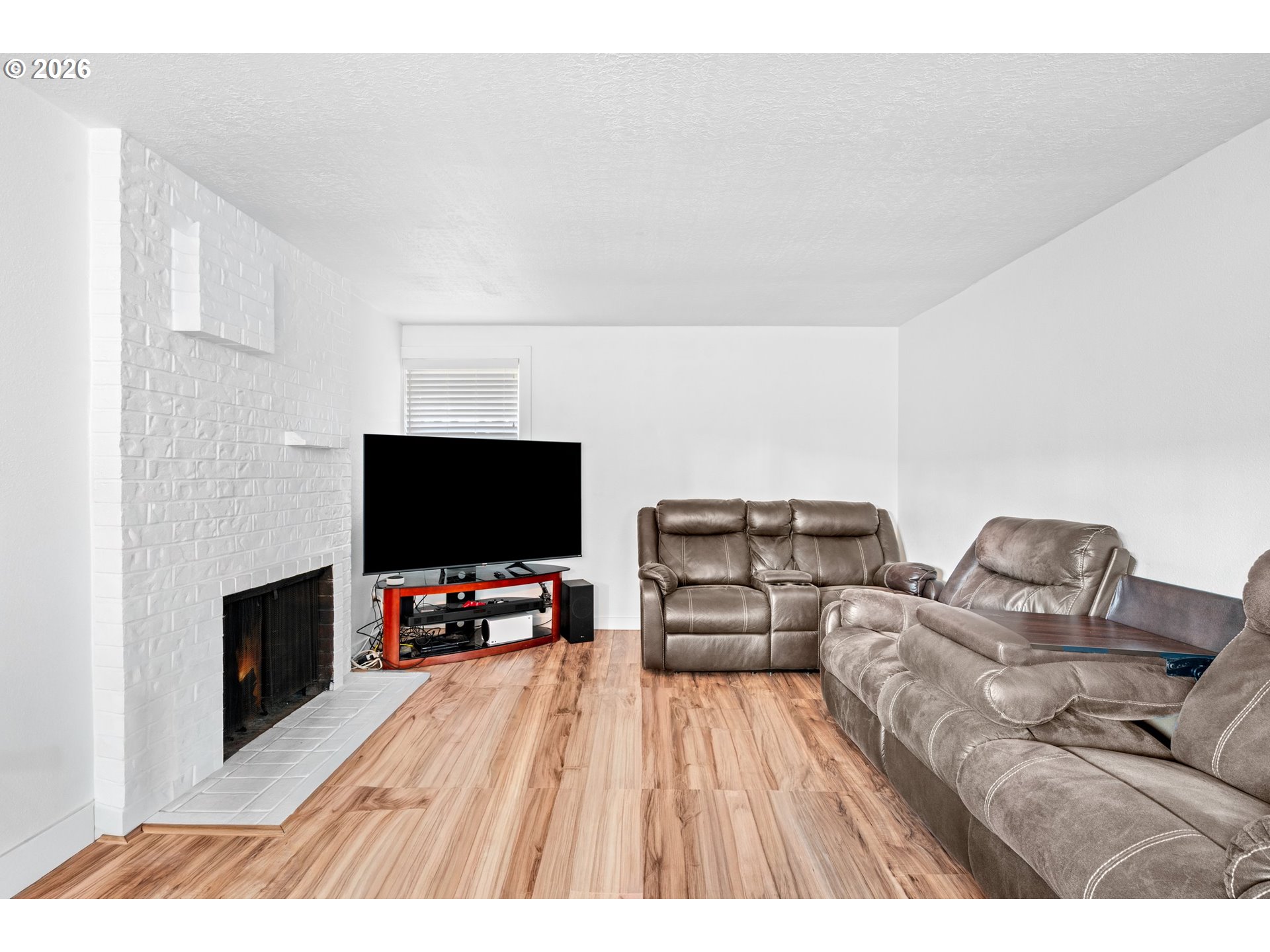 3311-3313 Northeast View Avenue Gresham, OR 97030 - Photo 19 of 26 a living room with furniture and a flat screen tv