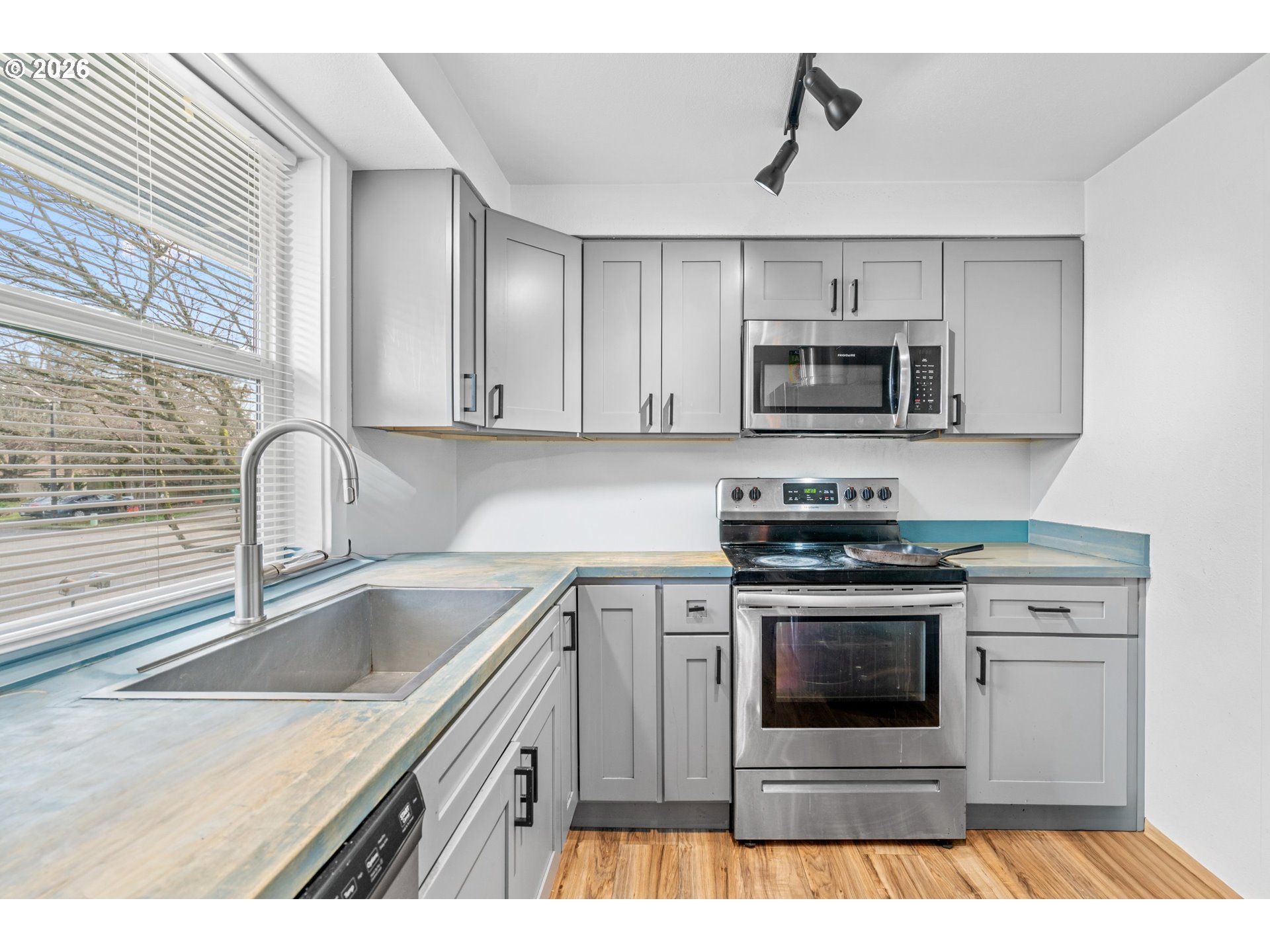 3311-3313 Northeast View Avenue Gresham, OR 97030 - Photo 5 of 26 a kitchen with a sink stove and microwave
