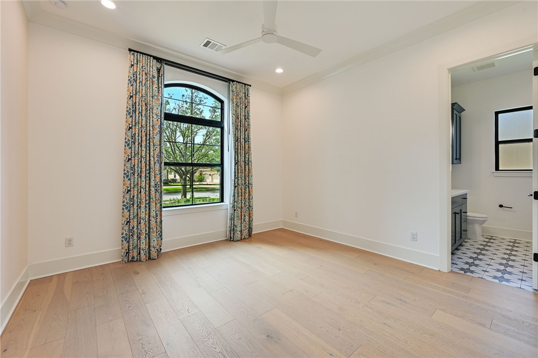 5115 Inverness Drive Bryan, TX 77802 - Photo 16 of 28 Bedroom featuring light wood finished flooring, a window, and a ceiling fan