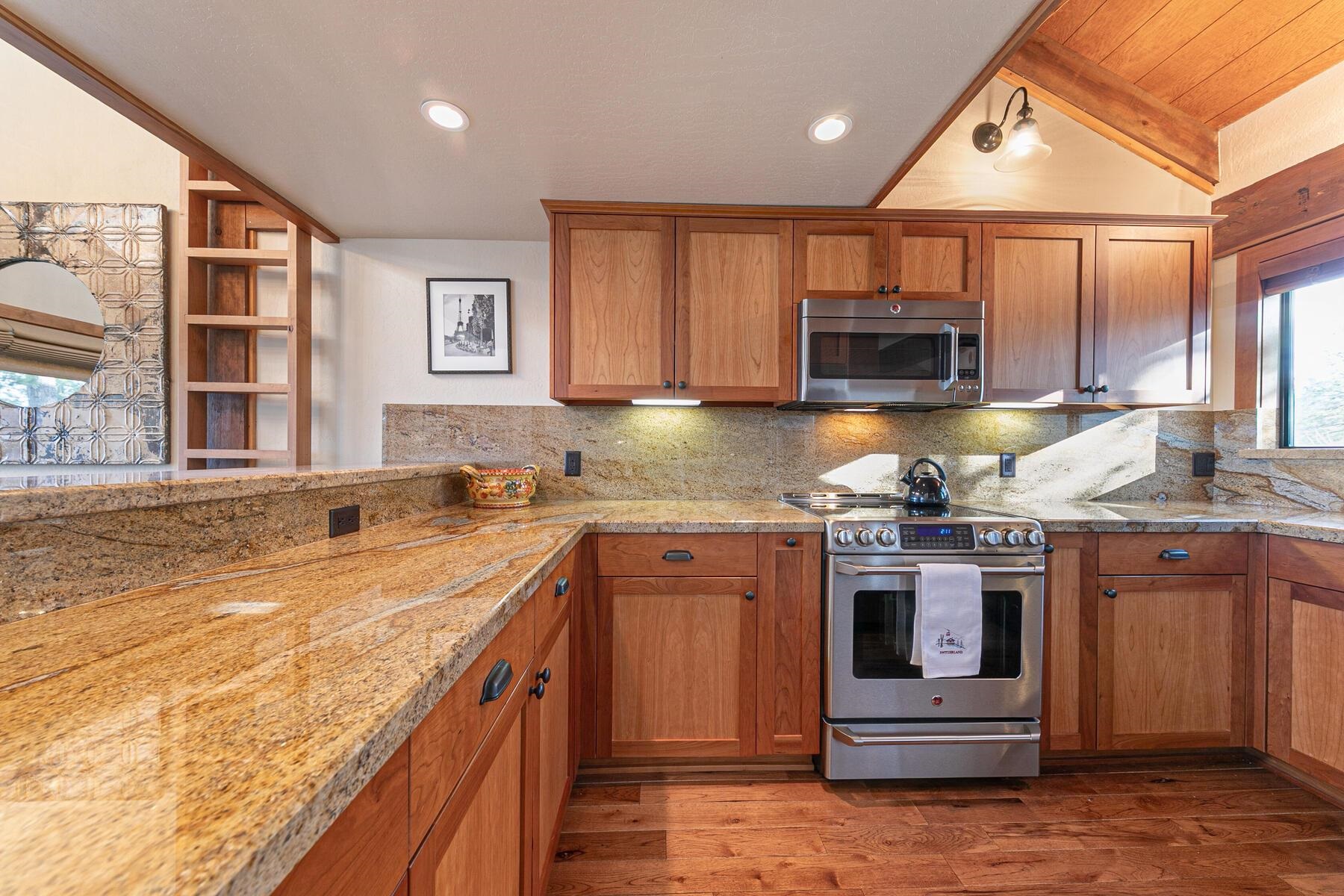 6108 Rocky Point Northstar, CA 96161 - Photo 9 of 28 a kitchen with stainless steel appliances granite countertop a stove a sink and a microwave