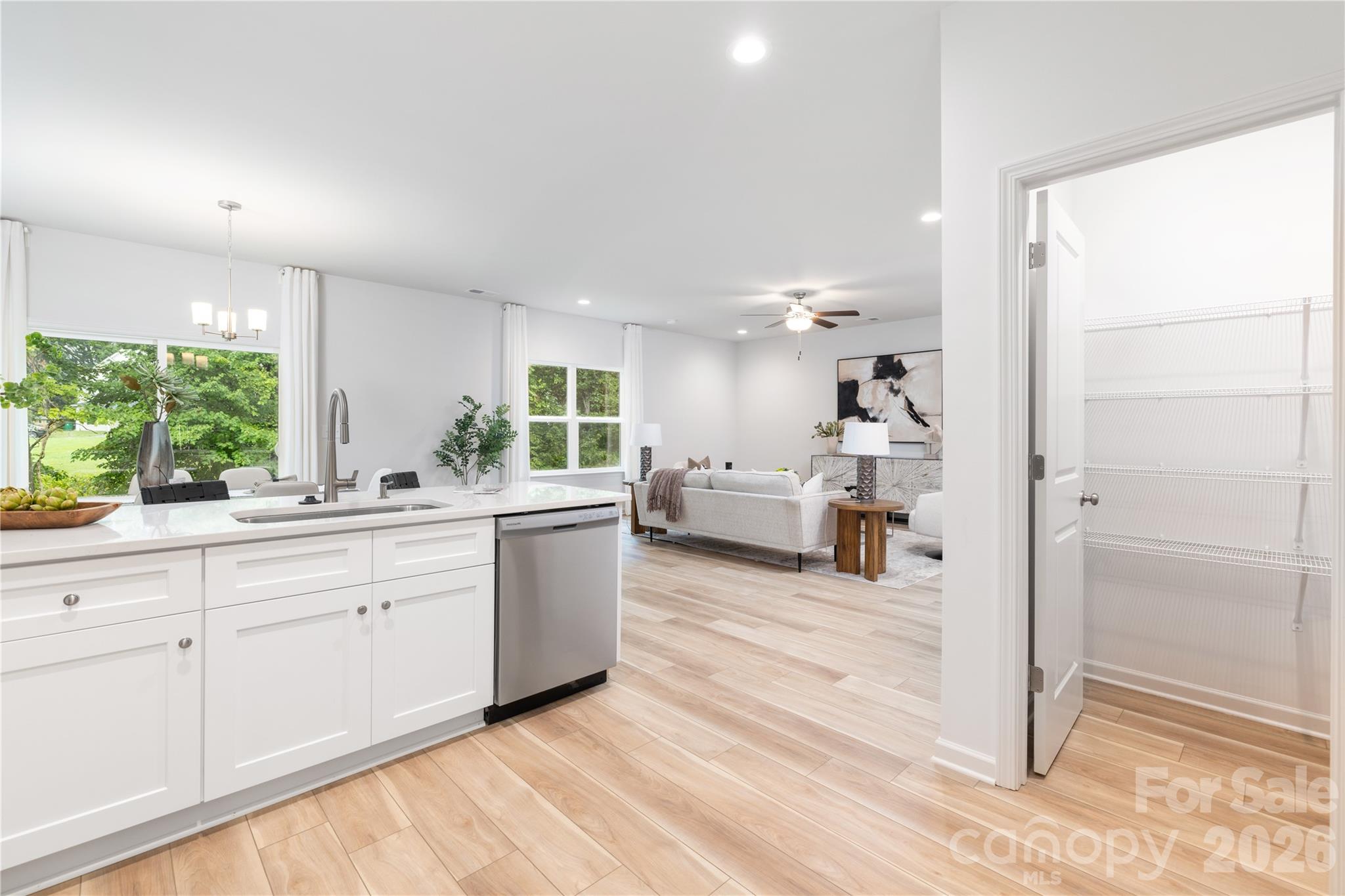 1418 Summerville Road Charlotte, NC 28214 - Photo 11 of 31 a large white kitchen with wooden floors and wide window