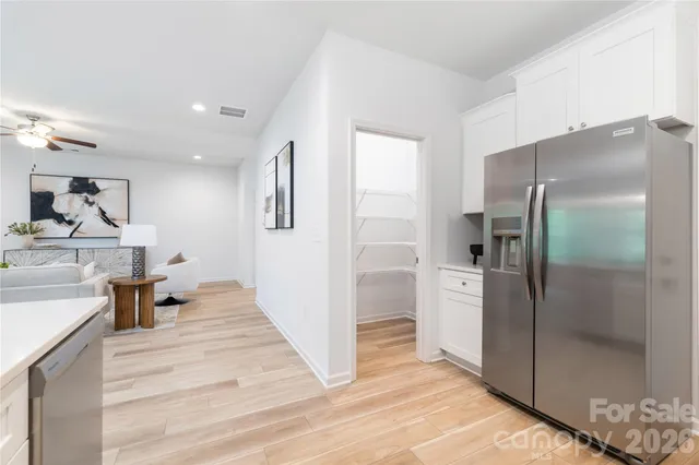 a kitchen with stainless steel appliances kitchen island a refrigerator and a sink
