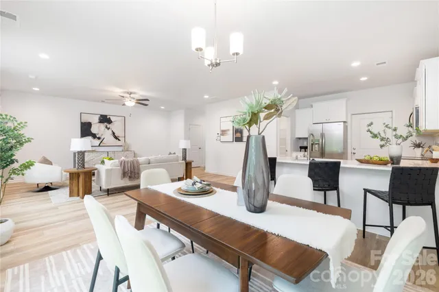 a living room with kitchen island furniture and a chandelier