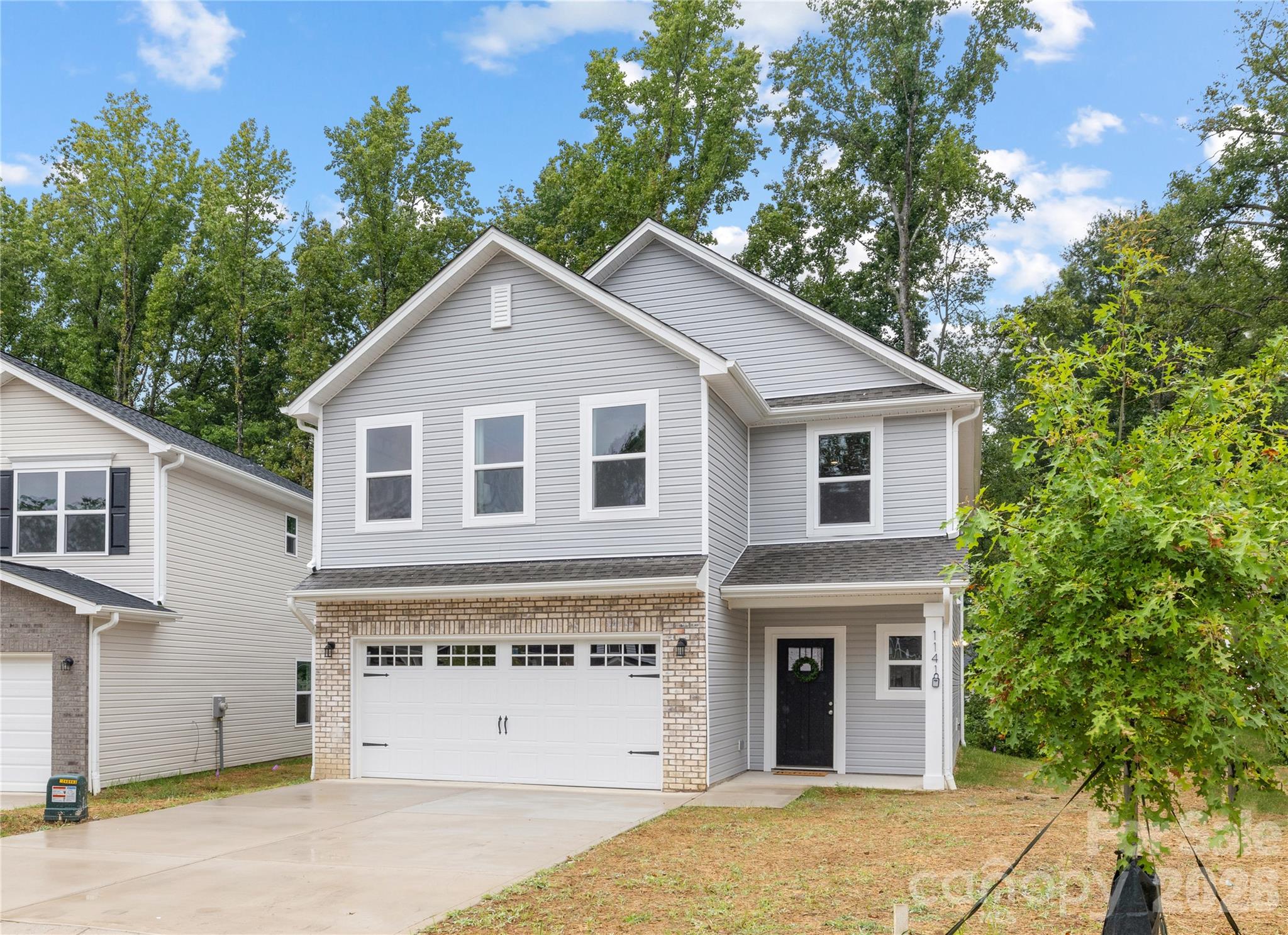 1418 Summerville Road Charlotte, NC 28214 - Photo 2 of 31 a view of a house with a yard and garage