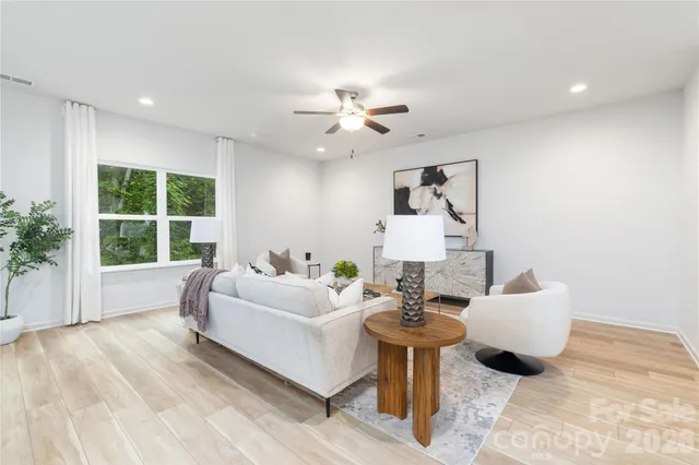 a living room with furniture and a large window