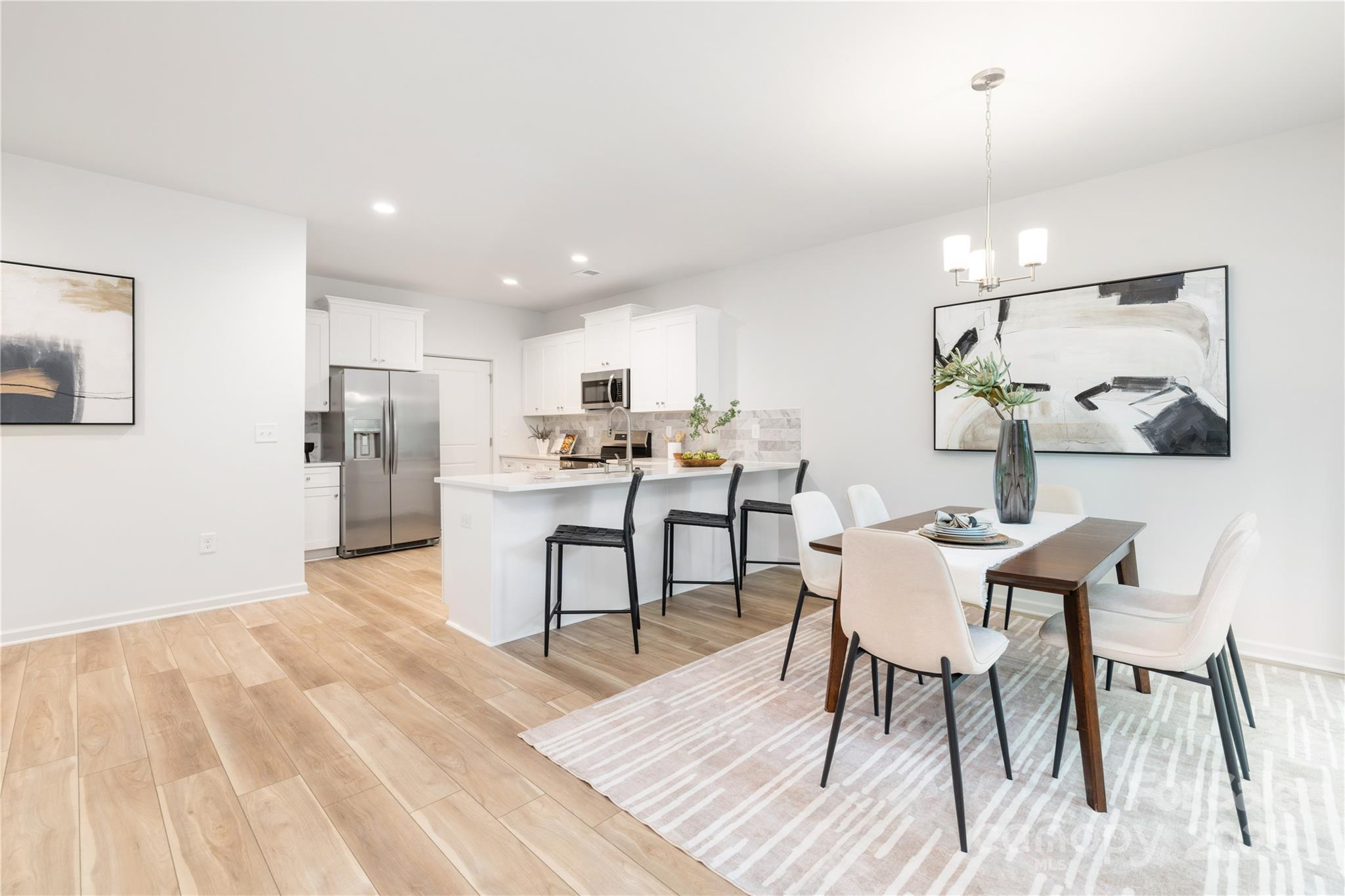 1418 Summerville Road Charlotte, NC 28214 - Photo 7 of 30 a view of a dining room with furniture and wooden floor
