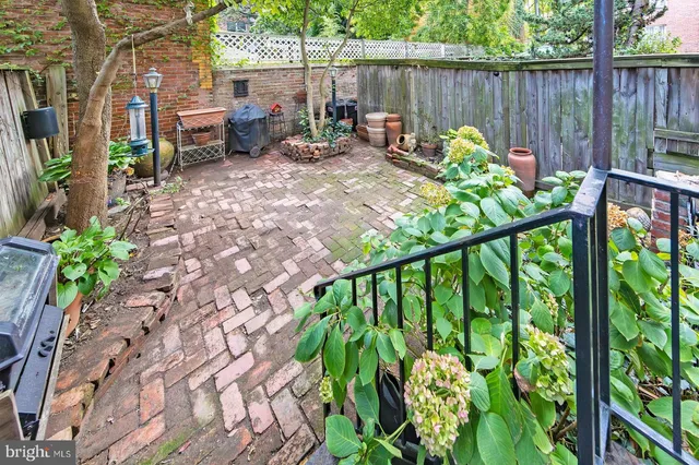 a view of a patio with couches table and chairs potted plants