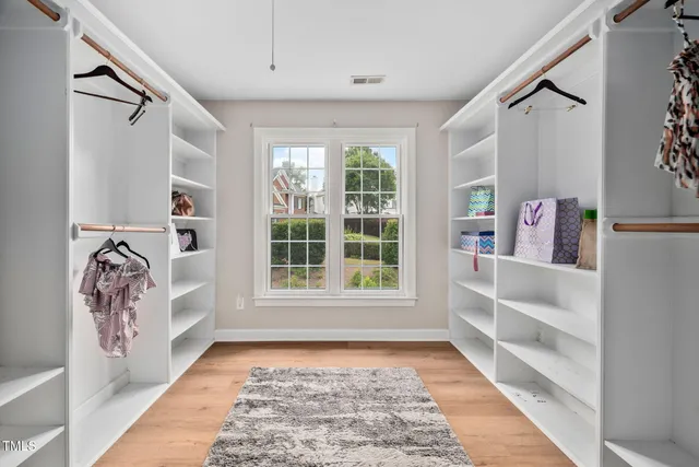 a view of hallway with stairs and a window