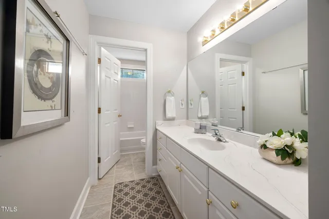 a spacious bathroom with a double vanity sink and a mirror
