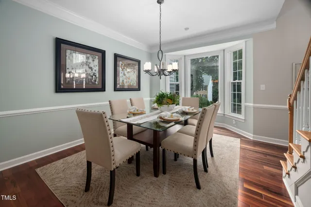 a view of a dining room with furniture wooden floor and a chandelier